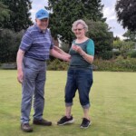 Ann presenting her husband John with the Consolation cup runners-up prize